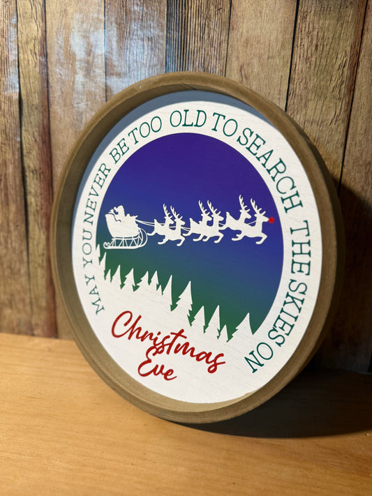 May you never be too old to search the skies on Christmas Eve, round sign
